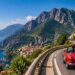 European road trip on scenic coastal highway with vintage car.
