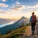 Hiker on scenic mountain trail at sunrise.