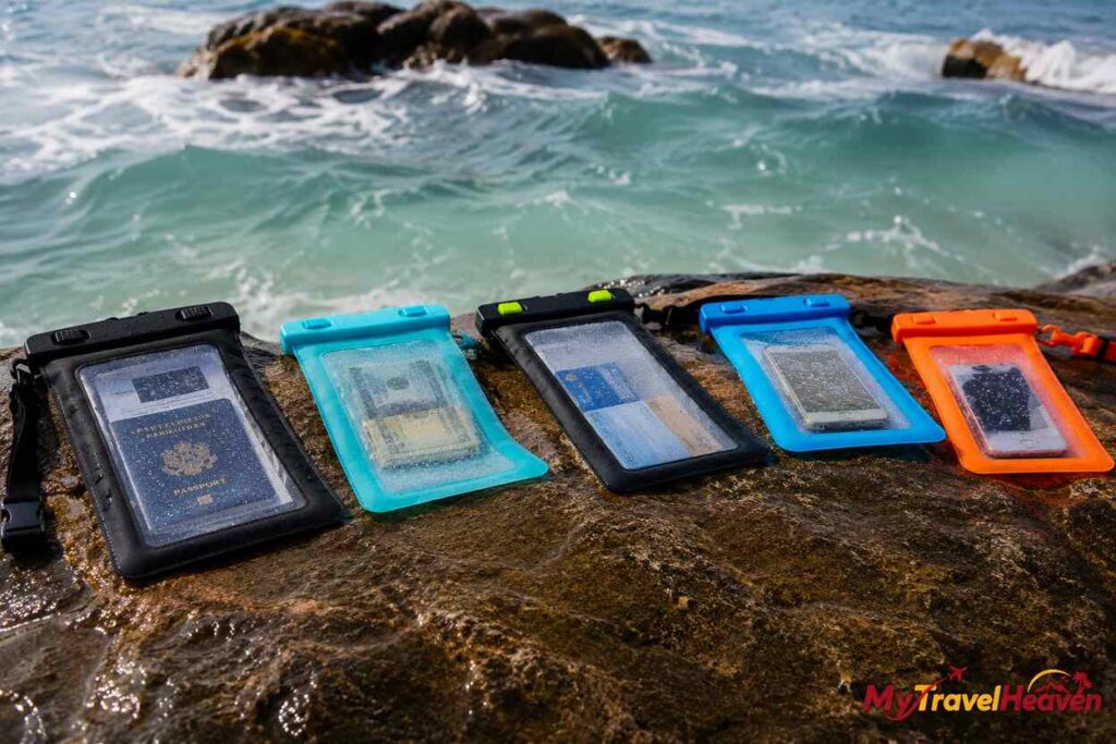 Waterproof document pouches displayed on a rocky beach with ocean waves in the background and the MyTravelHeaven logo in the bottom-right corner.